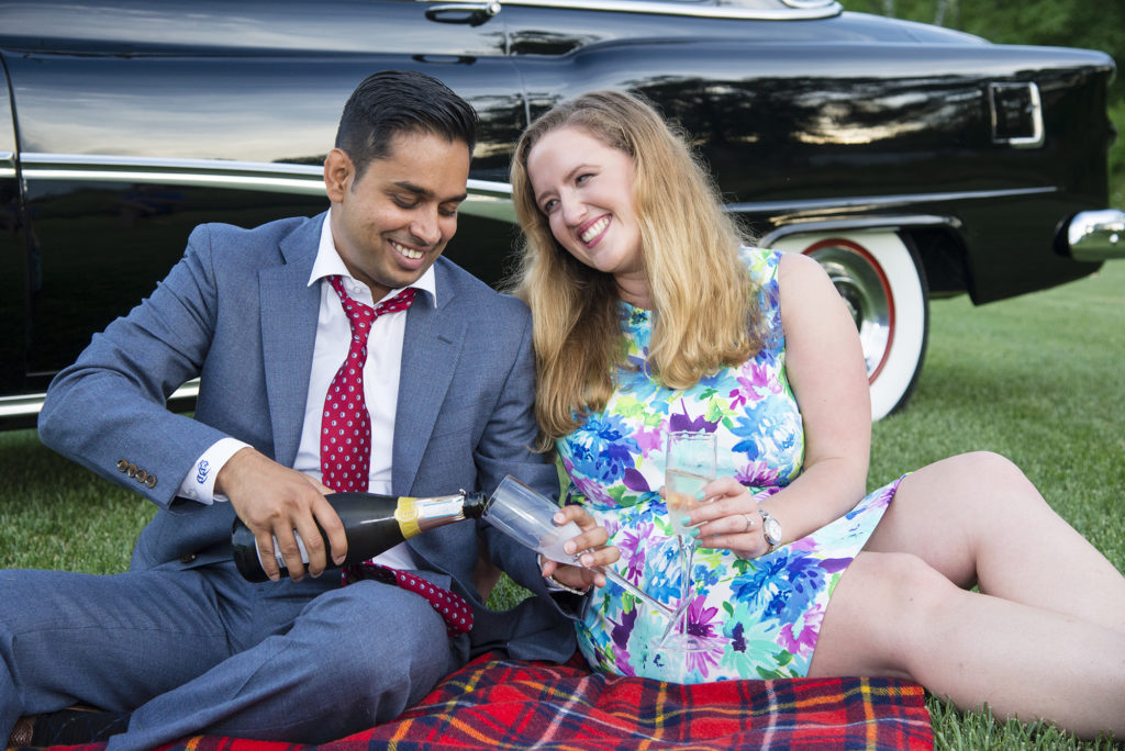 couple toasting by antique car