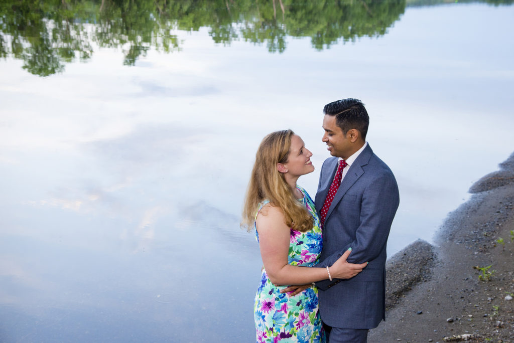 couple by stream with sky reflection