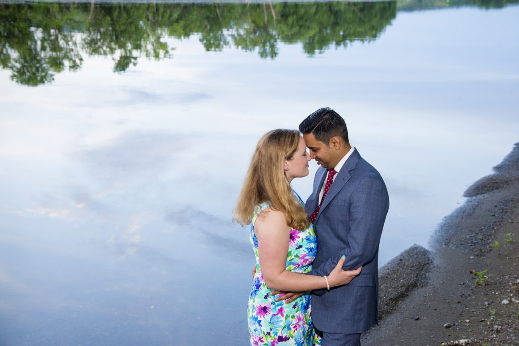 couple by stream and sky reflections